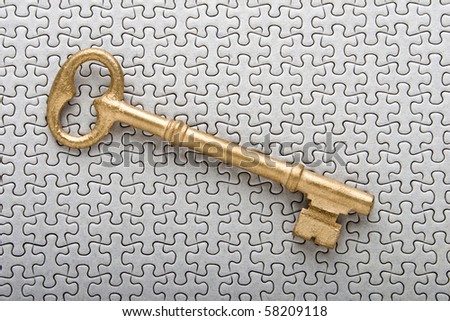 golden key on puzzle