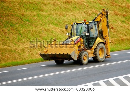 Construction machinery. Excavator coming back from construction