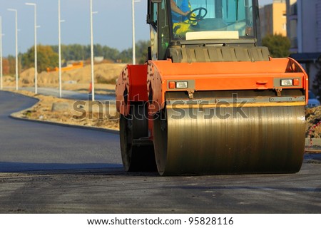Road construction. Large rolling machinery paving a road