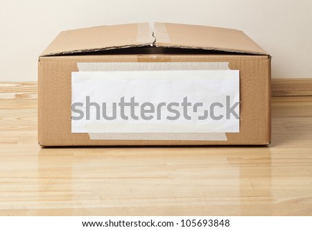 Cardboard box with blank label. Moving, storage concept.