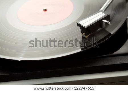 Vintage record player with spinning vinyl.