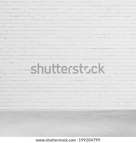 Empty white brick wall and concrete floor.