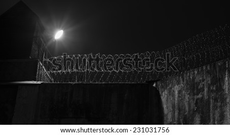 Prison wall, old jail fence at night.