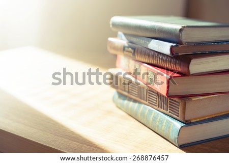Old books on wooden table.Shallow depth of field.