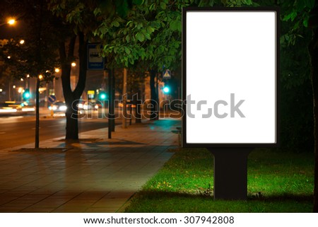 Blank advertising billboard in the city at night.