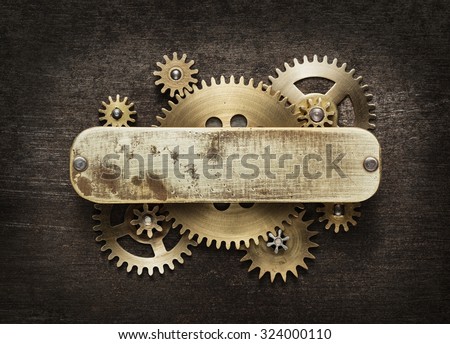 Clockwork mechanism background made of metal gears and brass plate.