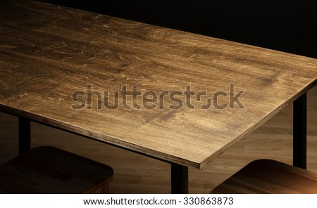 Empty rough wooden table top in the dark room