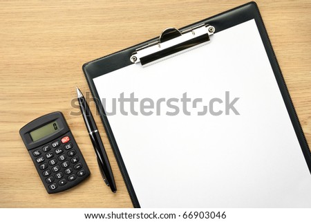 Office table with pen, calculator and empty paper for your text