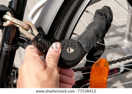 hand holding locked bike chain