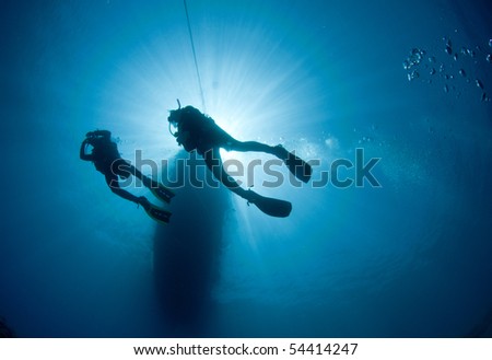 two scuba divers silouetted