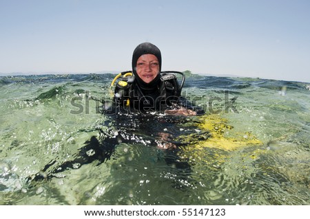 female scuba diver on the surface