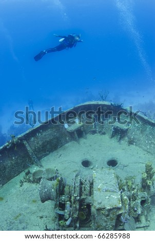 scuba diver fly\'s over a underwater ship wreck