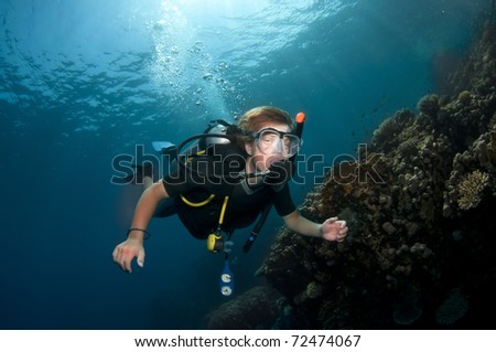 Scuba diving in the ocean with clear blue water