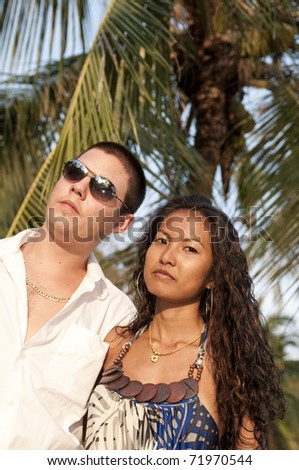 young couple on the beach, Thai girl and western man