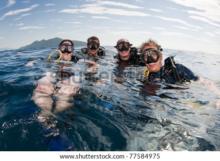 group of friends go scuba diving together