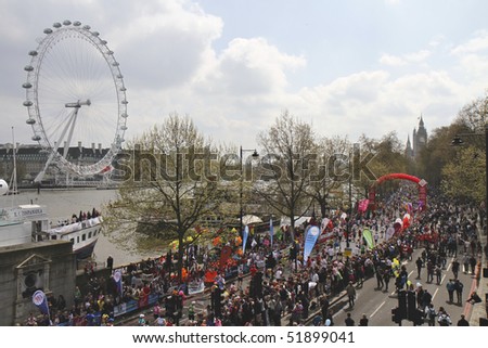 LONDON - APRIL 25: Runners taking part in the Virgin London Marathon on Embankment at the 25 mile marker next to the Thames on April 25, 2010 in Westminster, England
