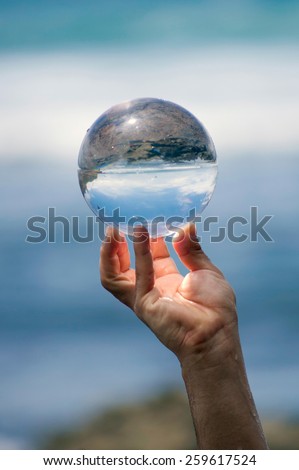 Glass ball in hand.