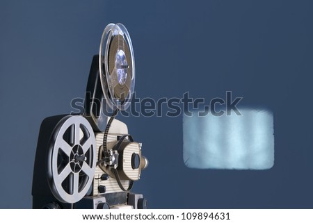 old movie projector with screen