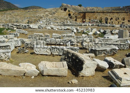 Panorama of Hieropolis with ruins of the city in the background and vividly littered remains of antiquities in the foreground
