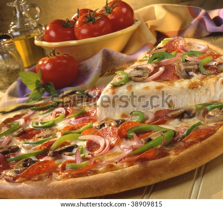 Pizza with pepperoni, peppers, onions and mushrooms