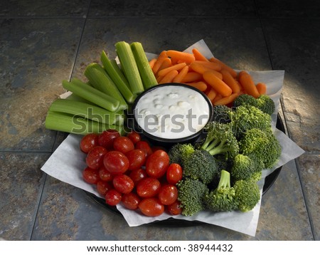 vegetable tray with broccoli, tomatoes, carrots, celery and blue cheese dressing