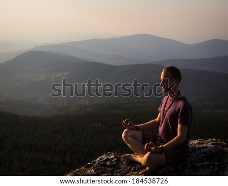 man meditation on a rock