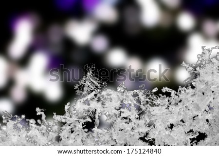 Closeup of snow crystals with a bokeh background. Nice background for Christmas or winter.