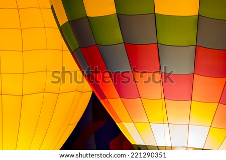 Colorful hot air balloons doing a night glow burn to light up the balloons for the crowd.