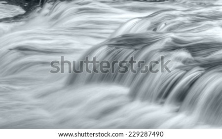 Close up of a waterfall during high water flow. Taken with a slow shutter speed to smooth out the flow of the water as is rushes by.