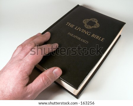A man touching the Bible isolated on white.