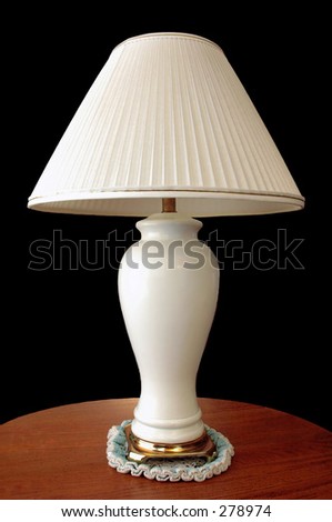Lamp on wood table with a black background