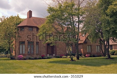 Brick home with a rounded area on the corner.