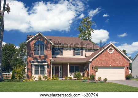 Beautiful brick home with a gorgeous blue cloudy sky. This is one of many in my home series.