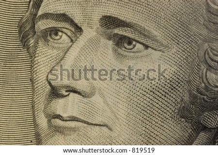 Macro of Alexander Hamilton portrait on the U.S. ten dollar bill.