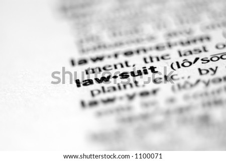 Extreme macro or close up of the word LAW-SUIT. Very shallow depth of field is intentional and shows only the word LAW-SUIT in focus.