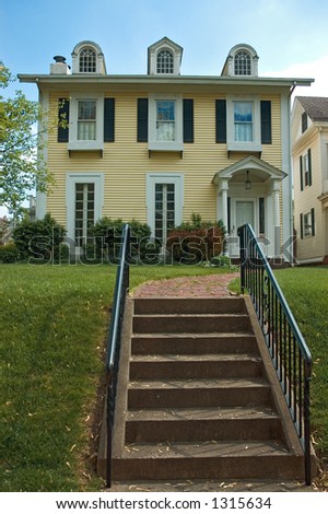More of a mix of Federal and Colonial architecture  home. Nice inviting stairway leads you to the porch. This house is located in the historic Lancaster Ohio.