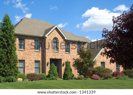 Beautiful and colorful brown two story brick home. Typical new home in the suburbs of the United States. Just one of many home or house photos in my gallery.