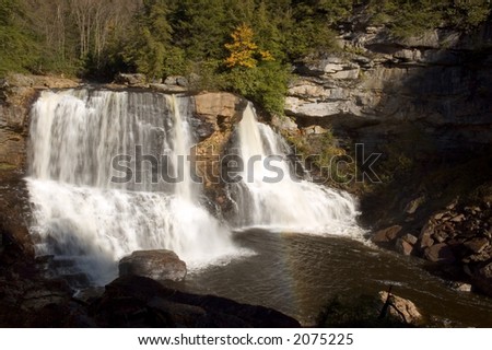 One of West Virginias most popular waterfalls, Blackwater Falls. You can also see a small rainbow in the pool below the falls.