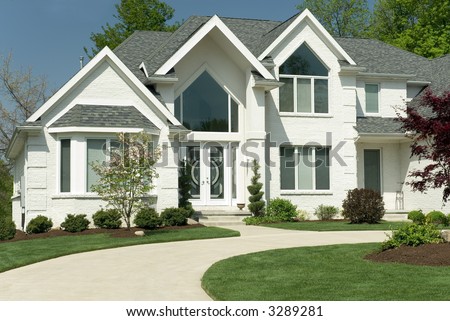 Beautiful white brick home featuring a modern architectural design 