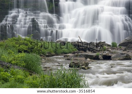 Chittenango Falls in Central New York state. This beautiful waterfall tumbles across many rock ledges creating a beautiul scene and an almost tropical setting with the lush green plant foilage.