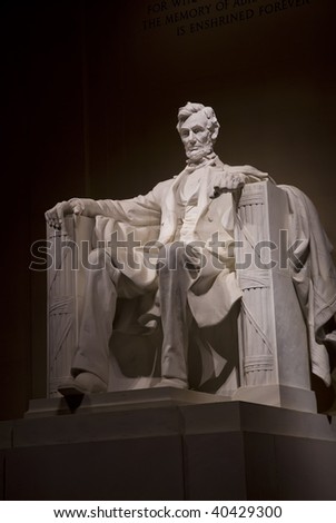 A night time shot of Abraham Lincoln\'s statue inside the Lincoln Memorial. Located on the National Mall in Washington DC.