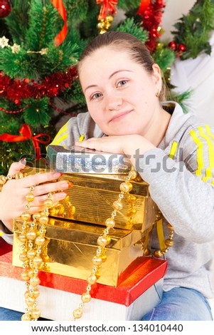 woman with a New Year tree and gifts in the room