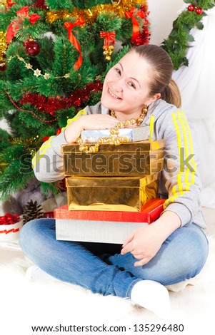 woman with a New Year tree and gifts in the room