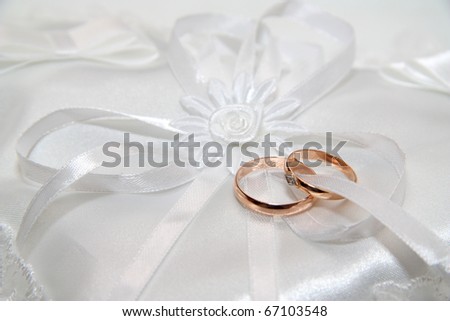 stock photo Two wedding rings on a white small pillow