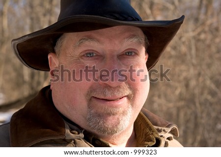 An older gentleman walking in the winter woods