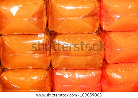 .Orange cushions in plastic wrap, Thailand.