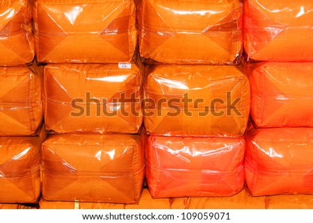 .Orange cushions in plastic wrap, Thailand.