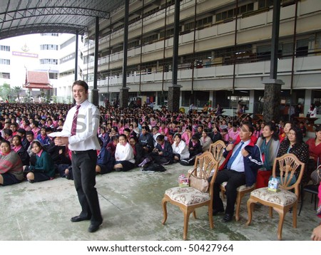 BANGKOK, THAILAND - DECEMBER 21 : English teacher gives speech while students sit outside for assembly at Seekan school December 21, 2005 in Bangkok.