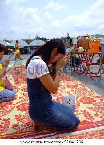 BANGKOK, THAILAND - APRIL 03: Thai woman worship a Buddhist shrine at a Buddhist festival in Suan Luang. April 03 2007 in Bangkok.