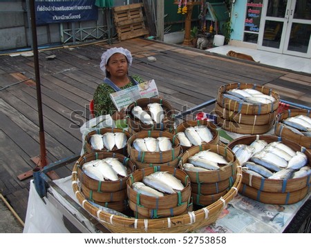 BANGKOK, THAILAND - MAY 17: Woman sells fish at fish market May 17, 2005 in Bangkok.